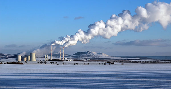 snowy landscape with steaming coal power plant
